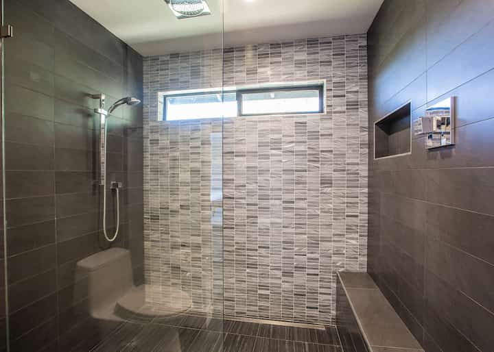 Grey bathroom remodel project with glassdoors in Apopka, FL.
